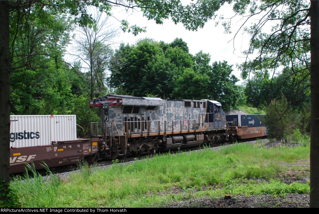 CSX 1776 is seen as a DPU on I032 traveling;east on the Trenton Line